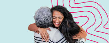 A younger woman hugs a senior woman