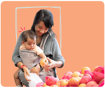 Woman with baby picking apples