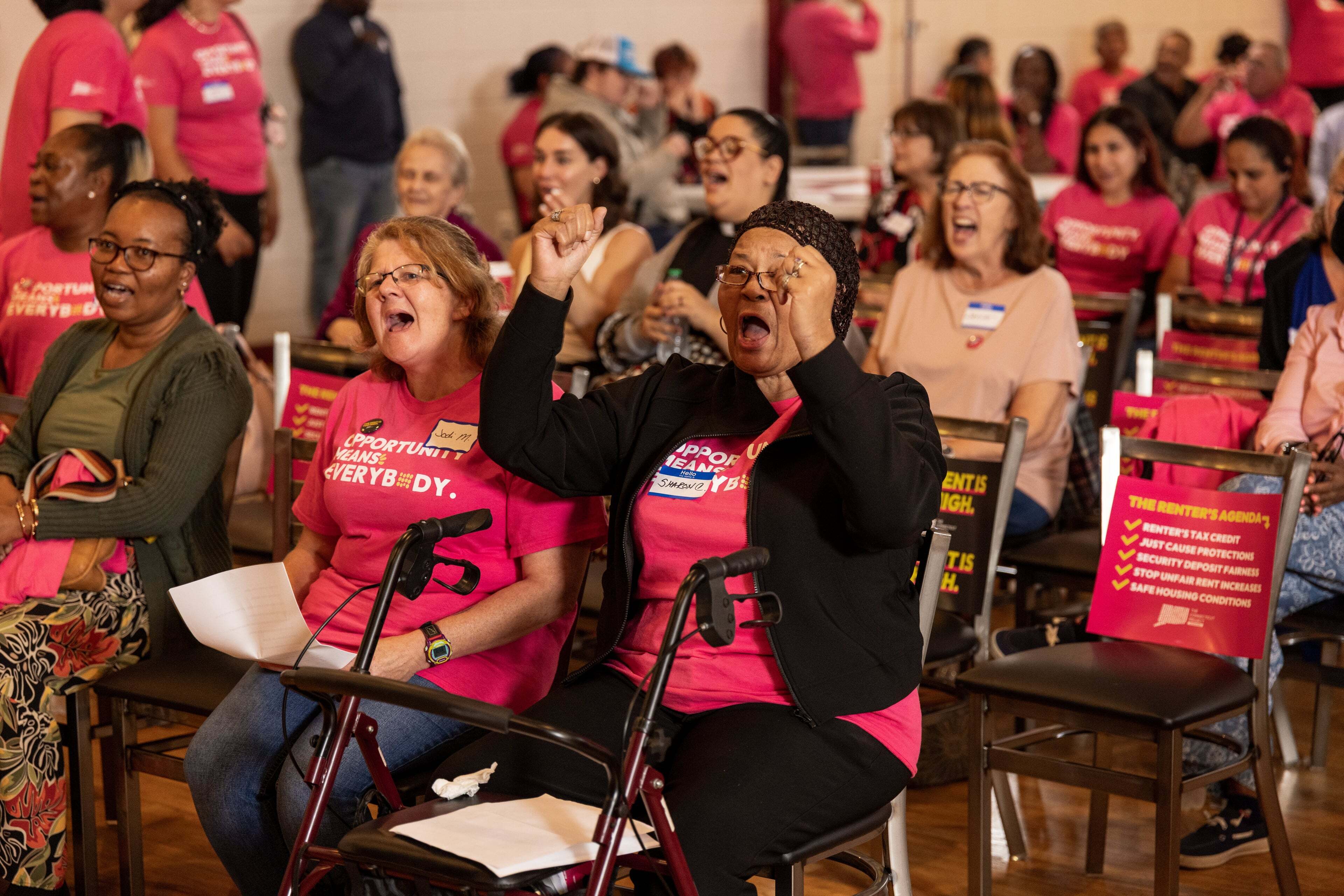 A crowd of people, many wearing pink 